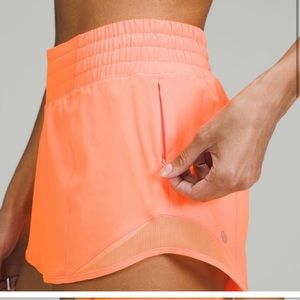 Highlight orange Hotty hot shorts. 4” high rise